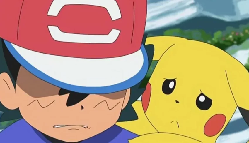 A boy is holding a pikachu and a hat.