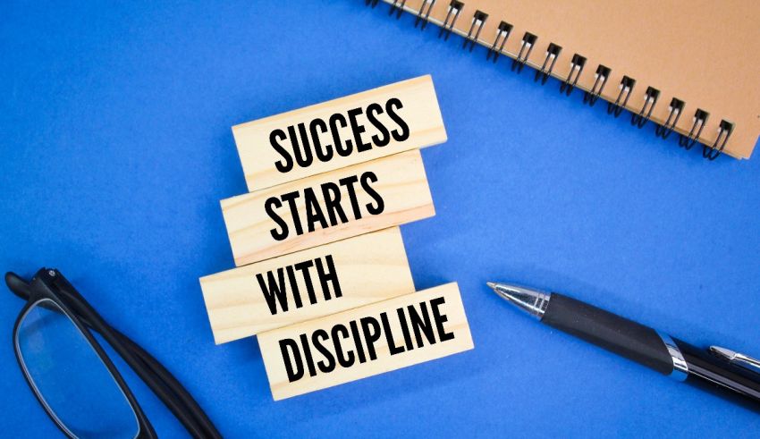 Success starts with discipline on a blue background with glasses and a notebook.