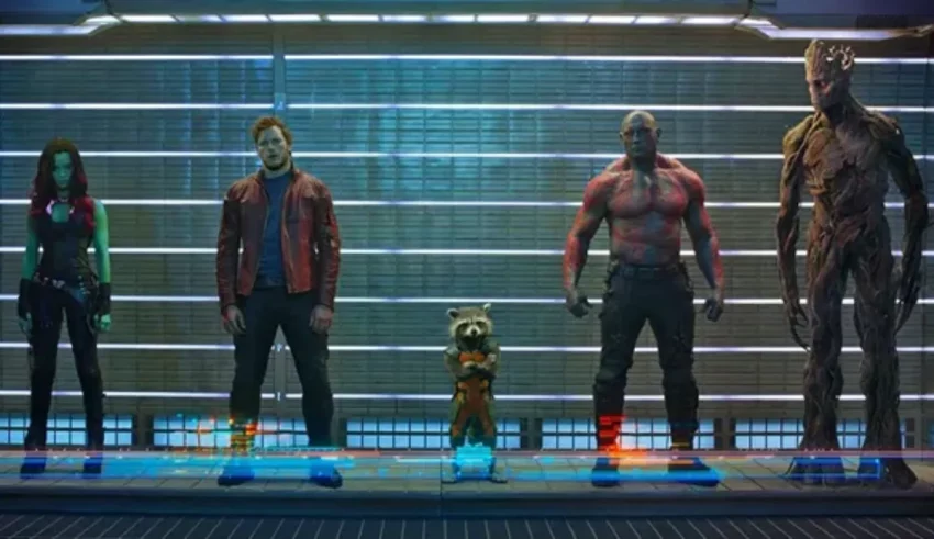 The guardians of the galaxy are standing in front of a wall.