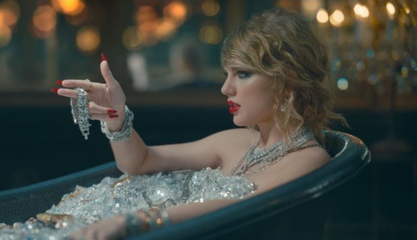 Taylor swift in a bathtub with jewelry.