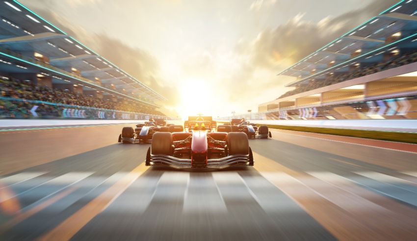 A group of racing cars on a track at sunset.