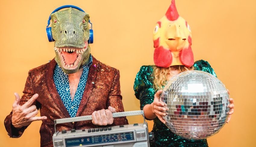 Two people dressed as a dinosaur and a t-rex holding a disco ball.
