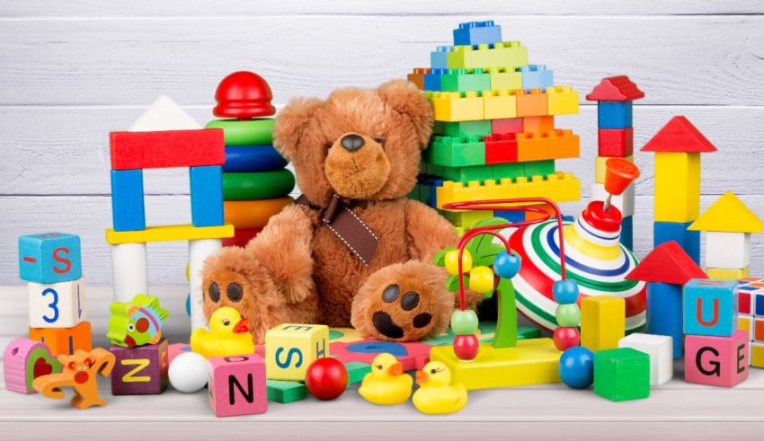 A teddy bear surrounded by blocks and toys.