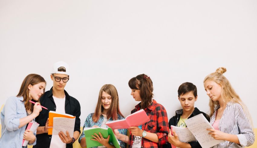 A group of young people looking at books.